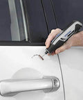 Dremel cordless rotary tool in hand, engraving near a car door handle.