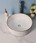 USZWBY Vessel Sinks Simple Hotel Bathroom Ceramic Sink Home Round Above Table Basin with gold rim and modern faucet.