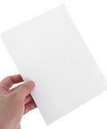 Hand holding a single white piece from a 12 Pack Vinyl Wall Repair Patches Self Adhesive Skirting Crack Fix Tape For Walls And Fences Hole Repair DIY Home Improvement Kit For Drywall Plaster Vinyl Panels And Wood Surfaces That Keeps Walls Looking Fresh.