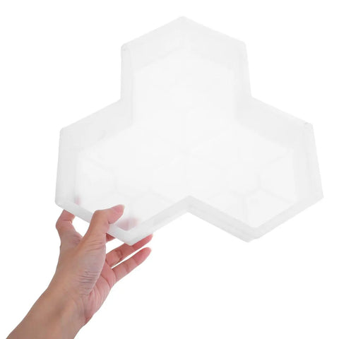 Hand holding a Maple Leaf Concrete Brick Mold Set 2 Pieces Reusable Stepping Stone Paver for Garden Patio Lawn Walkway.