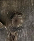 Close-up of wood grain showing a knot, illustrating natural texture. Straight Up True Ebony Aging Wood Stain For Bare Interior Wood Projects One Coat Water Based Dark Finish That Reacts With Natural Tannins Dries Fast And Easy Cleanup Five Gallons.