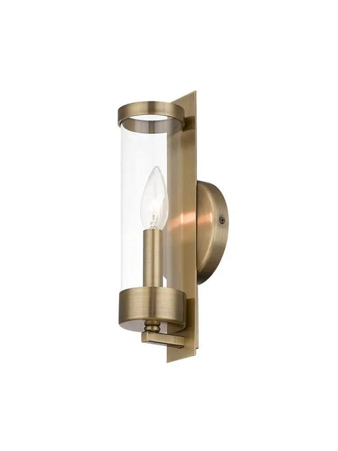 Castleton Antique Brass 1 Light ADA Wall Sconce with Clear Glass Cylinder, side view showing antique brass and clear glass.