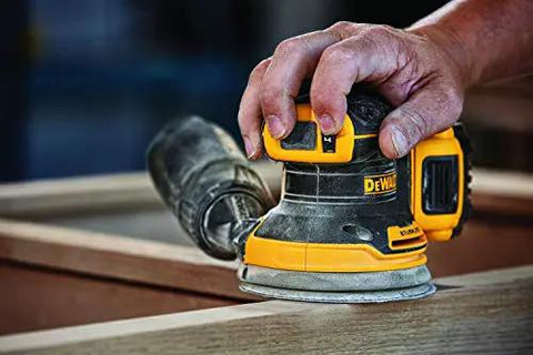 Person using 20V Max Brushless Orbital Sander Tool Only With Variable Speed Control 8000 To 12000 OPM Low Profile Body For Close Work Replaceable 8-Hole Hook And Loop Sanding Pad on wooden surface