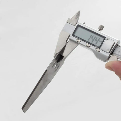 Measuring a metal blade from Eight Piece Metal Lawn Mower Saw Blades And Replacement Heads Set For Cordless Mowers with caliper