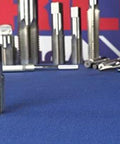 Front view of Drill America POU set featuring 1/8 NPT pipe tap and high-speed steel drill bits on blue work surface