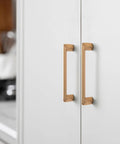 Champagne Bronze Zinc Alloy Cabinet Handles 5 Inch Center To Center 128mm installed on white cabinet doors