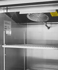 Interior view of Heavy Duty Kickass Commercial Kitchen Workhorse Upright Refrigerator Featuring Rock Solid Construction with shelves and fan.