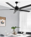 Heavy Duty Industrial 5 Speed Ceiling Fan With Remote And Five Rugged Black Blades For Serious Quiet Cooling In Living Rooms Kitchens And Bedrooms, installed in a dining area.