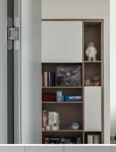 Adjustable 180 Degree Invisible Cross Hinge For Folding Doors Zero Gap Hidden Mechanism shown on modern shelving unit.