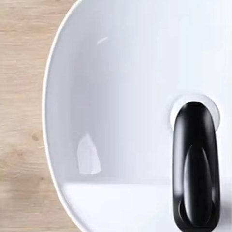 Top view of USZWBY Vessel Sinks Minimalist Ceramic Table Basin with black drain plug, ideal for bathroom or balcony use.