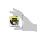 Hand holding Powerlock Tape Measure 16 Ft Pro Grade With True Zero And 3/4 Inch Blade, showing compact size. Closed chrome ABS case.