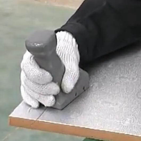 Hand using Pro Grade Pre Insulated Duct Panel Cutter Kit With Five Cutter Heads Featuring Straight, 45 Left, 45 Right, Side Shape, And V Shape Cuts Color Coded For Quick ID Works With Polyurethane Duct Panels on edge of duct panel.