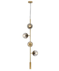 Lit Four Light Smoky Gray Glass Globe Pendant Light With Adjustable Cord And Gold Accents, modern mid-century chandelier.