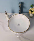 USZWBY Vessel Sinks Simple Hotel Bathroom Ceramic Sink Home Round Above Table Basin with gold trim on a marble countertop.