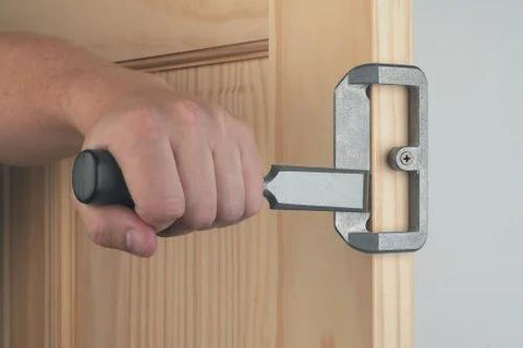 Door Lock Installation Kit For Wooden Doors With Self Centering Jig Adjustable Backset Two And Three Eighths Or Two And Three Quarters Inches Includes Carbon Hole Saws For Wood Router Bit And Bolt Plate Templates Interior And Exterior Door Install shown in use on a wood door