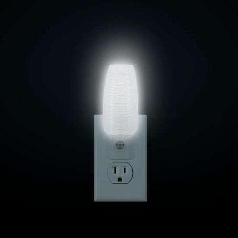 MLN 16 LED Plug In Night Light With Auto Dusk To Dawn Sensor And 5000K Daylight Illumination 5 Lumens glowing in outlet.