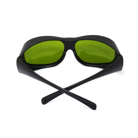 Top Tier Infrared Laser Safety Glasses Loaded With Multi Band Optical Density Shields And Slick Clear Lenses Crafted Hella Tough For Nd Yag Diode And Garage Laser Builds, black frame with green lenses.
