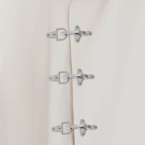 Four Pairs Of Silver Zinc Alloy Web Joint Buckles For Crafts, Built Tough To Beat Wear And Tear, Adjustable Airplane Style Buckles For DIY Projects, Perfect For Belts, Straps, Bags, And Garments. Three silver zinc alloy web joint buckles on light fabric.
