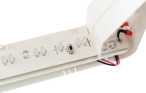 Close-up of Single Sided LED Exit Sign With White Thermoplastic Housing, showing internal switchable red and green colors wiring.