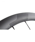 Close-up of 40mm Carbon Clincher Wheelset For Disc Brake Road Bikes Centerlock Rotor Mount 700c Black, highlighting rim details.