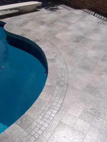 Premium Dead Simple Water Based Non Slip Floor Sealer And Coating For Slippery Tiles And Concrete applied on textured patio near pool.
