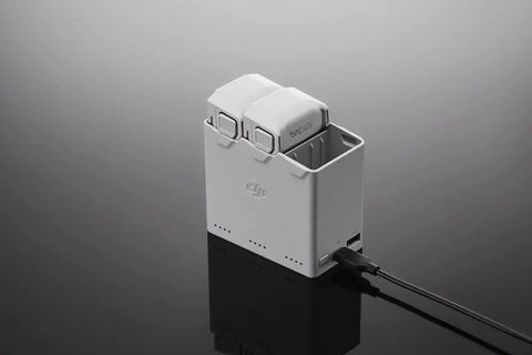 30W USB-C Two-Way Charging Hub for Mini 3 Pro batteries with two installed, showing ports and compact design on black surface.