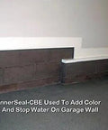 Superior Heavy Duty One Step Concrete Sealer And Curing Compound With Deep Penetrating Internal Moisture Vapor Barrier For Natural Stone And Cultured Rock Hella Tough Zero Hassle Protection applied to a garage wall.
