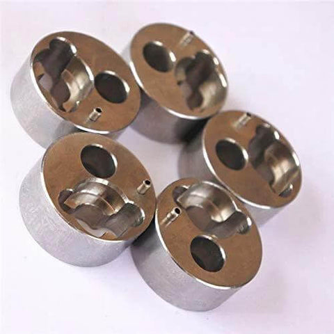 Top view of five metal poppet housings, 7/8 inch water jet pump components