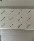 KRETLAW grease gun box, white cardboard packaging with a repeating KRETLAW logo pattern.