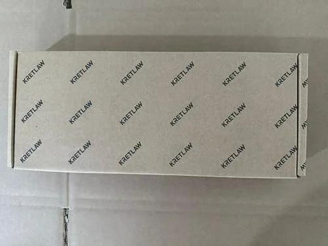 KRETLAW grease gun box, white cardboard packaging with a repeating KRETLAW logo pattern.