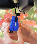 Blue ResqMe emergency car escape tool installed on visor clip with lanyard and keyring