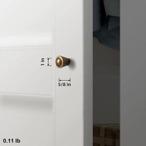 Six Pack Antique Brass Cabinet Knobs With Fluted Trumpet Ends installed on a kitchen cabinet door, dimensions 1 inch by 5/8 inch.