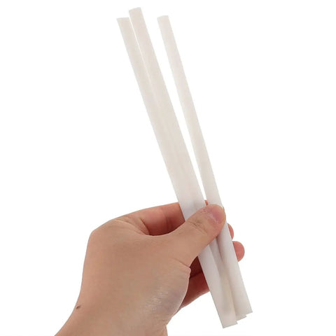 Hand holding three white PP strips from the Top Rated Plastic Welding Rods Set For Car Bumper Repair Kit Includes 40 Pcs Of Durable White Pp Strips That Fix Cracks And Breaks Like A Pro Without Breaking The Bank.