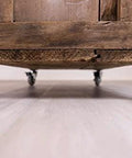 Furniture piece with corner casters on hardwood floor showcasing 1.5 Inch Round Non-Marking Rubber Slip-On Chair Leg Tips.
