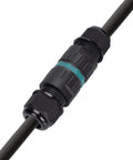 Close-up of black M25 waterproof cable connector with teal ring on a cable