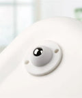 Close-up of a nylon ball caster from the Four Pack Universal Self Adhesive Ball Casters For Heavy Storage Bins And Plastic Tubs Silent Swivel Furniture Glides Hassle Free Glide Kitchen Bedroom Bathroom Organizers Super Quiet Nylon Rollers Move With Ease.