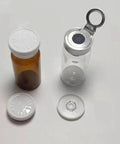 Two GISUREM 10ml glass bottle and empty vial: amber bottle with white cap; clear vial with flip-off aluminum cap