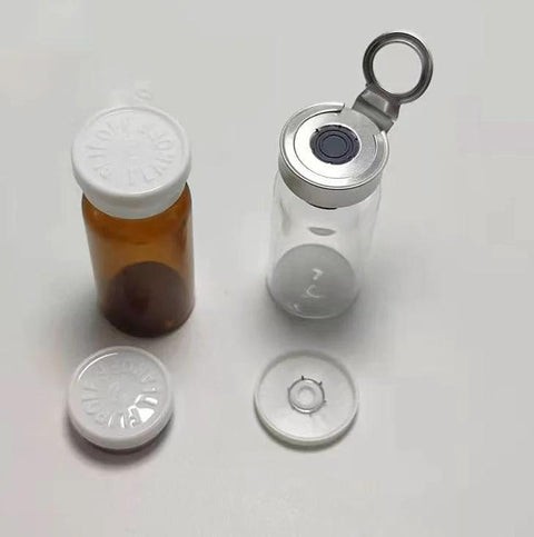 Two GISUREM 10ml glass bottle and empty vial: amber bottle with white cap; clear vial with flip-off aluminum cap
