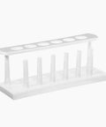 25mm Plastic In Line Test Tube Rack With Drying Pins For 6 Tubes White Polyethylene Lab Gear Organizer That Holds 20 To 25mm Tubes With 28mm Hole Diameter For Easy Drying And Storage, showing six drying pins and tube holes.
