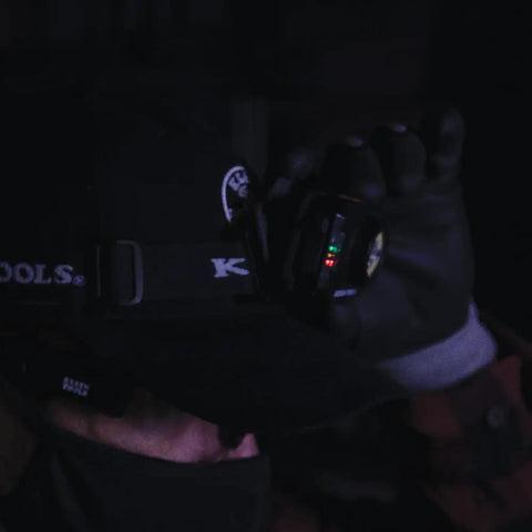 Person wearing Rechargeable Two Color LED Headlamp With Durable Fabric Strap and Red LED Indicator in dim light