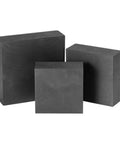 Three graphite blocks, showcasing a Graphite Square Block For Electrolysis And Heater Parts Electrode Plate With Plasticity 7 By 50 By 100 Mm Durable.