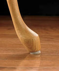 Wooden chair leg with 1 Inch Round Self Adhesive Felt Furniture Sliders For Hard Floors Leveling Pads To Stop Scratches Scuffs And Noise