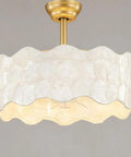 Padxpouo Boho Fandelier Ceiling Fan with light featuring a unique white caged lampshade and gold ceiling mount.