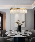 Sleek Gold Glass Pendant Light Adjustable Led Hanging Fixture With Cyan Crystal For Living Room Prime Pick Home Glow Up Solid Setup And Chic Everyday Vibes over a round dining table.