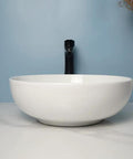 USZWBY Vessel Sinks Modern Simple Round Sink Home Bathroom Above Counter Basin showing white ceramic bowl sink with black faucet.
