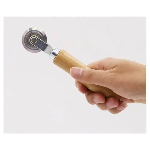 Hand holding Pro Grade Box Resizer Tool with solid wood handle and high precision bearing roller for scoring cardboard.