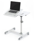 Smooth Rolling Tilt Top Height Adjustable Standing Desk With Heavy Duty Carbon Steel Frame And Locking Wheels For Seamless Over Bed Workstations And Lowkey Productive Home Office Vibes featuring a laptop on a mobile desk.