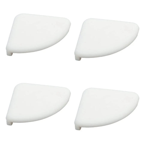 Four white silicone corner guards from a 36 pack, designed for furniture. Silicone Corner Guards for Furniture, 36 Pack Baby Safe Edge Bumpers.