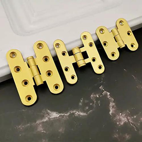 Close-up of the Five Pcs Brushed Brass Deco Furniture Hinges Set shown on a table, designed for jewelry boxes, cabinets, and more.