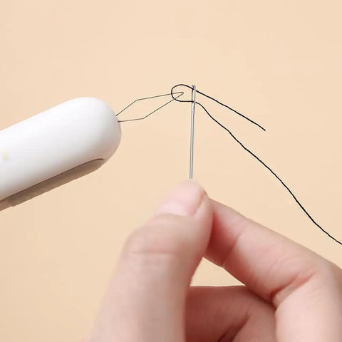 Close-up of 3 Pack 2 In 1 Needle Threader And Seam Ripper Set For Sewing Threading And Seam Removal in use with needle and thread.